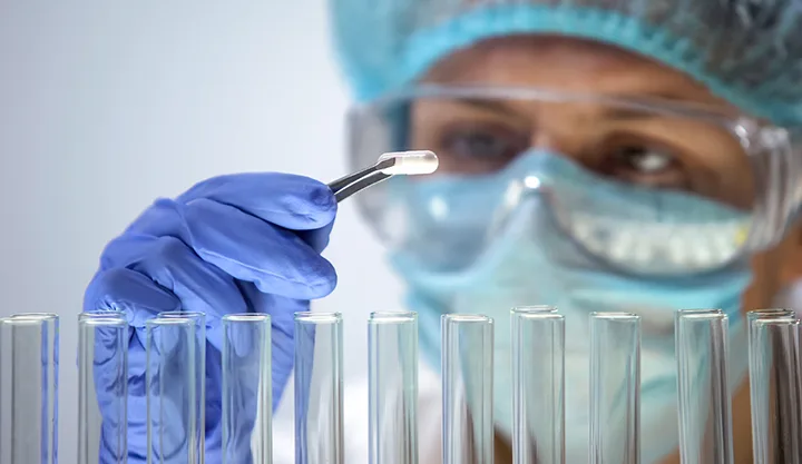 lab tech with testing tubes