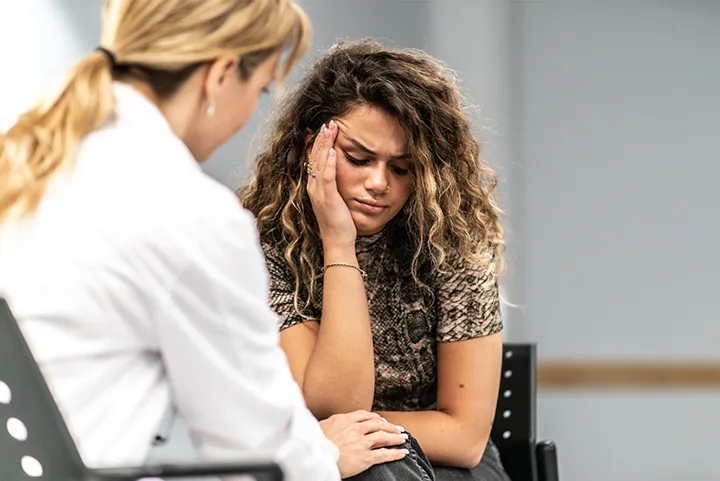 depressed woman talking with doctor